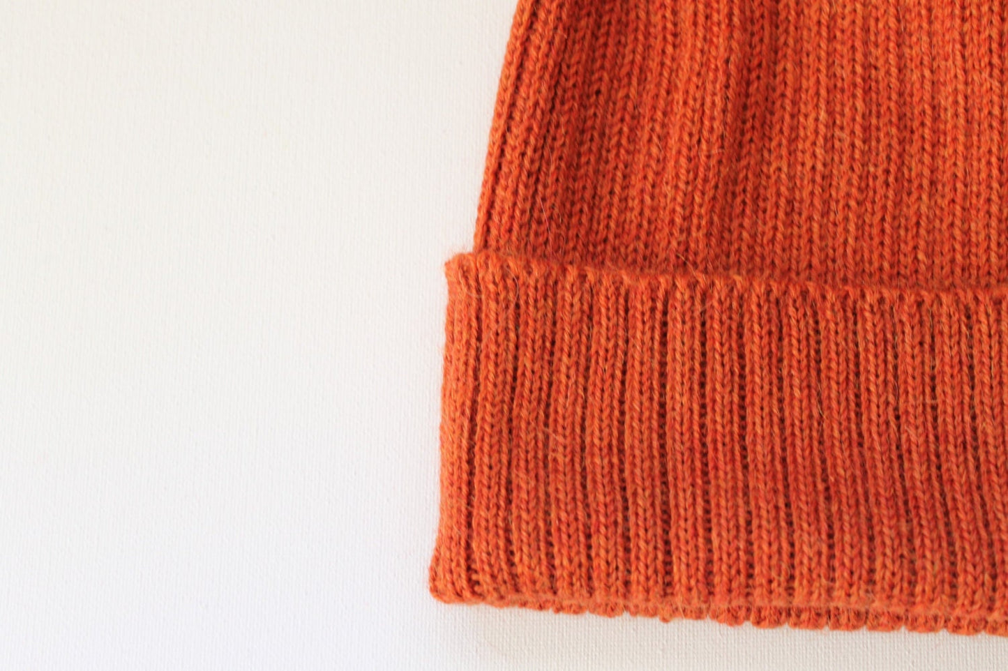 Rust/ burnt orange knitted alpaca beanie hat for babies, toddlers and children. Handcrafted in Scotland. Unisex design.