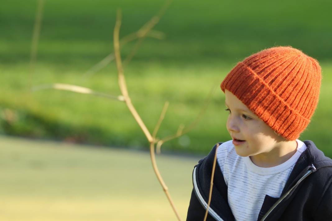 Rust/ burnt orange knitted alpaca beanie hat for babies, toddlers and children. Handcrafted in Scotland. Unisex design.