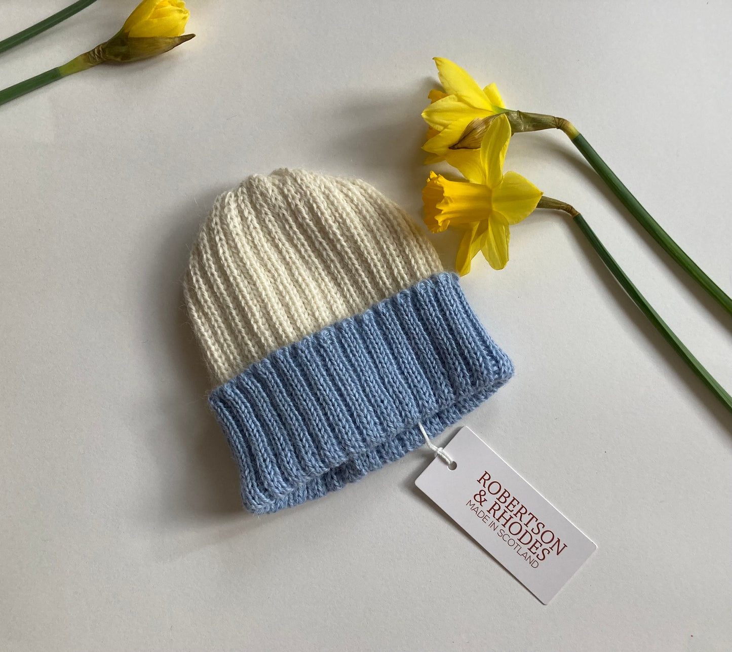 Light blue/ecru knitted 100% alpaca beanie hat for babies.  Handcrafted in Scotland. Unisex light blue/ecru watch cap.