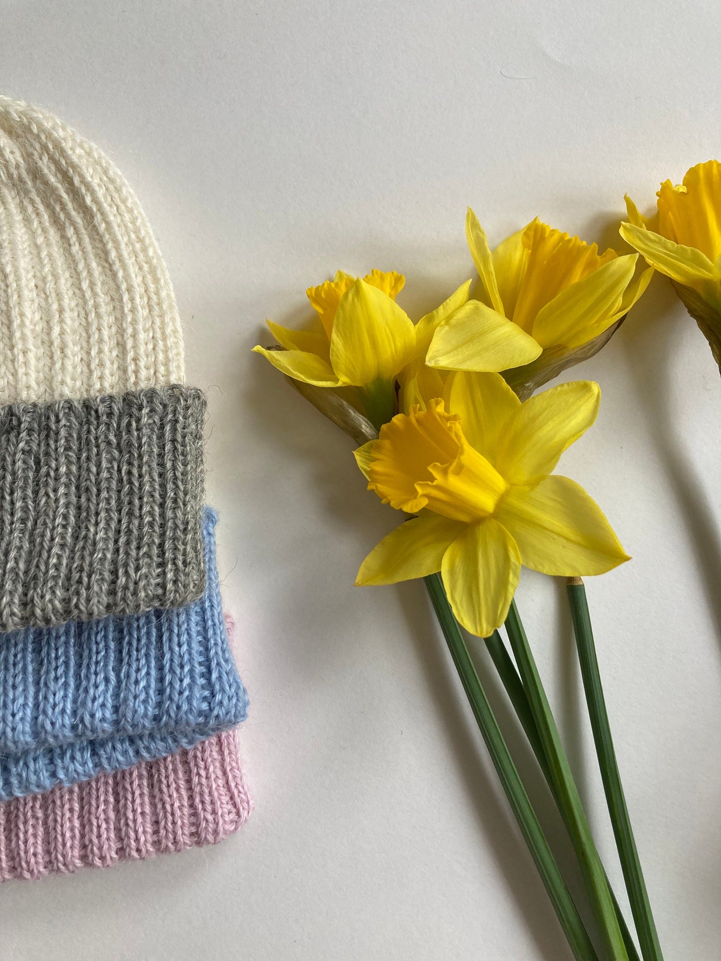 Light blue/ecru knitted 100% alpaca beanie hat for babies.  Handcrafted in Scotland. Unisex light blue/ecru watch cap.